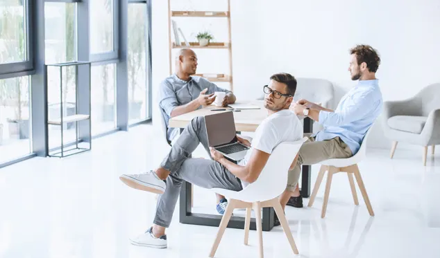 Colleagues talking in a bright office